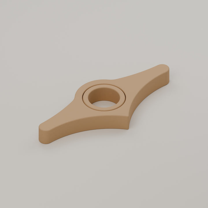 Light brown book page holder with the thumb ring lying flat